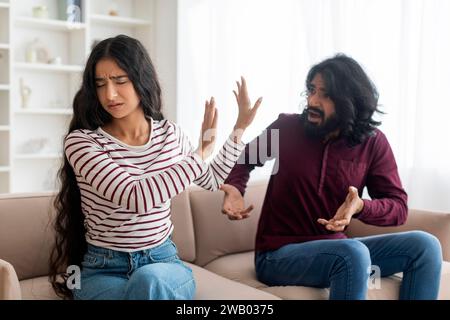 Emotional young indian man gesturing and shouting at his girlfriend Stock Photo