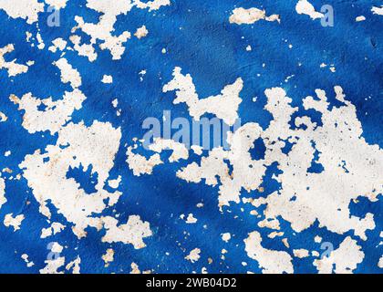 Abstract background of shabby concrete wall surface with dark blue and white paint and weathered parts. Vintage decorative elements. Stock Photo