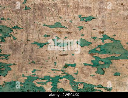 Old weathered and cracked green paint on a wooden surface. Abstract shabby background with vintage texture. Rustic style. Stock Photo
