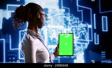 Admin updating AI systems using mockup tablet, writing intricate binary code scripts. Engineer using programming to upgrade simulation model, using augmented reality to visualize result Stock Photo