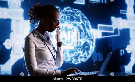 African american engineer develops artificial intelligence neural networks architecture inspired by human brain. Woman with IT expertise setting up AI machine learning algorithms in high tech startup Stock Photo