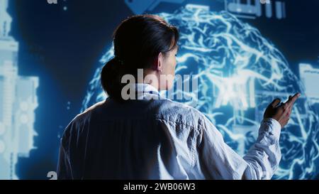 Overseeing manager developing artificial intelligence neural networks architecture inspired by human brain. Meticulous inspector setting up AI machine learning algorithms in high tech startup Stock Photo