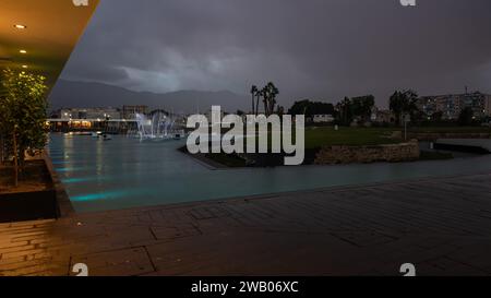 Palmero, Sicily, Italy, December 16, 2023 - Luxury restaurant and fountain during twilight at the yacht harbor of Palermo Stock Photo