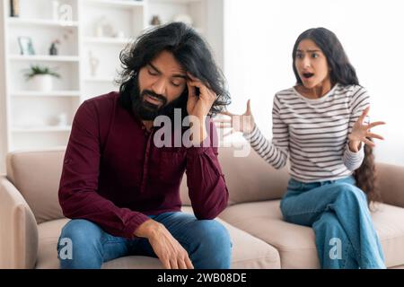 Emotional young indian woman gesturing and shouting at boyfriend Stock Photo