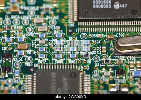 Closeup macro of flat chip resistors on a 1990s circuit board. Stock Photo