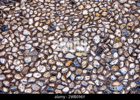 Weathered old cobble stone background of pebbles and stones Stock Photo
