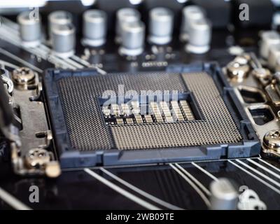 Closeup view of a CPU socket on a black motherboard, semiconductor electronic industry, printed circuit board, computer science Stock Photo