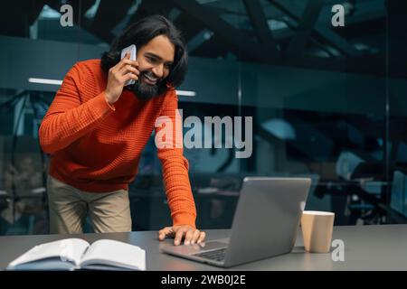 Millennial indian man project manager working at modern office Stock Photo