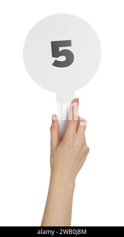 Woman holding auction paddle with number 5 on white background, closeup Stock Photo