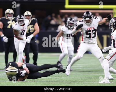 New Orleans, USA. 07th Jan, 2024. New Orleans Saints quarterback Taysom Hill (7) dives past Atlanta Falcons linebacker Nate Landman (53) during a National Football League game at Caesars Superdome in New Orleans, Louisiana on Sunday, January 7, 2024. (Photo by Peter G. Forest/Sipa USA) Credit: Sipa USA/Alamy Live News Stock Photo