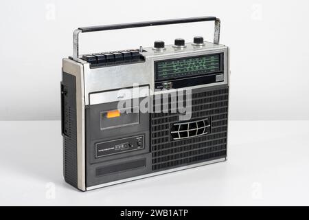 Vintage portable radio with cassette tape player over white background. Stock Photo