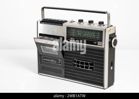 Vintage portable radio with cassette tape player over white background. Stock Photo