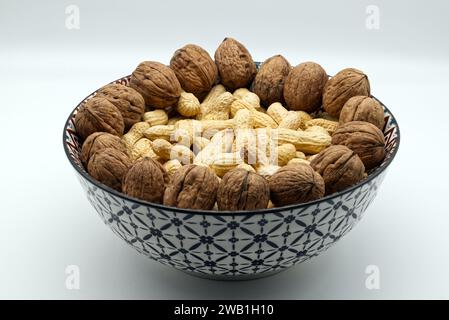 Walnuts and peanuts  in a bowl isolated on white background Stock Photo