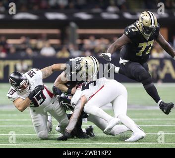 New Orleans, USA. 07th Jan, 2024. Atlanta Falcons defensive end Joe Gaziano (99) and Atlanta Falcons linebacker Nate Landman (53) both tackle New Orleans Saints quarterback Taysom Hill (7) while guard Cameron Erving (77) leaps over the pile during a National Football League game at Caesars Superdome in New Orleans, Louisiana on Sunday, January 7, 2024. (Photo by Peter G. Forest/Sipa USA) Credit: Sipa USA/Alamy Live News Stock Photo