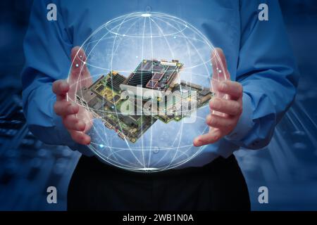 A man holds a stylised, highlighted earth with some industrial embedded CPU boards inside. Concept of Global Industrial Computer Automation. Stock Photo