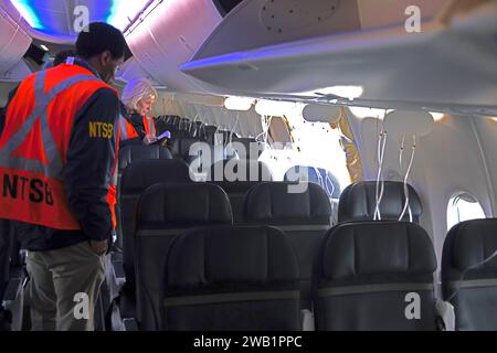 NTSB investigation of the Jan. 5 accident involving Alaska Airlines Flight 1282 on a Boeing 737-9 MAX. NTSB investigators in the aircraft cabin, near the hole in the fuselage where the door plug failed. Stock Photo