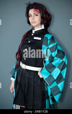 A Caucasian female cosplayer in a blue costume with face paint and red contact lenses Stock Photo