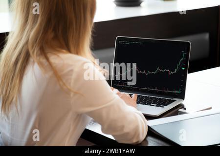 Unknown female trader makes stock market research Stock Photo