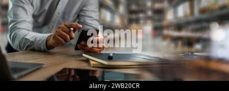 man Worker hands holding phone showing smart inventory dashboard Digital internet network (IoT) Smart logistics warehouse management Stock Photo
