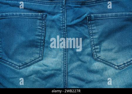 Blue denim jeans trousers back pockets as background, texture of material Stock Photo