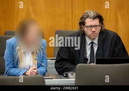 Essen, Germany. 08th Jan, 2024. The defendant sits next to her lawyer David Bleikamp in the courtroom. She is alleged to have given her grandmother two drinks in March and July 2023, which were allegedly laced with a high dose of sedatives. According to the indictment, the 31-year-old was after her grandmother's assets and inheritance. Credit: Christoph Reichwein/dpa - ATTENTION: Person was pixelated by order of the court for legal reasons/dpa/Alamy Live News Stock Photo
