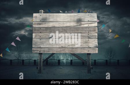 Old rough wooden sign and dark cloudy sky: horror and Halloween concept, blank copy space Stock Photo