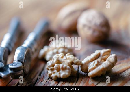 Walnut nut kernels with a vintage silver nut cracker close up. Food photography Stock Photo