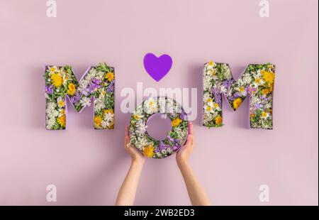 Word MOM Of Spring Flowers Inside Cardboard Boxes.Bouquet for Mothers Stock Photo