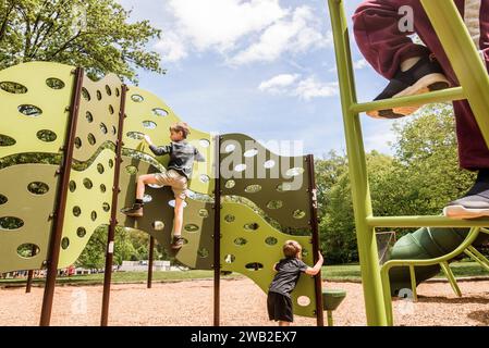 Playground with feet in foreground and two children behind Stock Photo