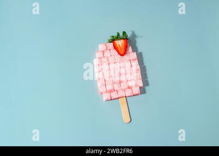Strawberry Sugar Cube Popsicle on Blue Background Stock Photo