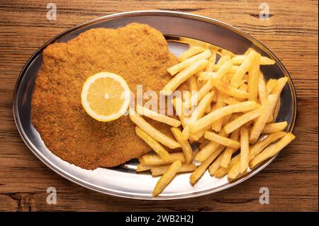 Overhead view of a plate of Milanese with French fries Stock Photo