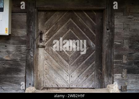 Sunja, Croatia, 05,04,2021: Old wooden rustic door on rural home wall. Stock Photo
