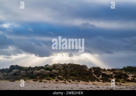 Rain clouds and sun rays over Findhorn beach sand dunes. Findhorn, Morayshire, Scotland Stock Photo