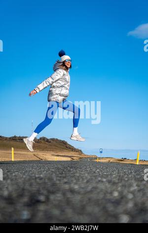 A young Caucasian woman posing on the beach against the sea Stock Photo