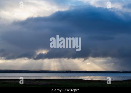 Rain clouds and sun rays over Findhorn bay nature reseve. Findhorn, Morayshire, Scotland Stock Photo