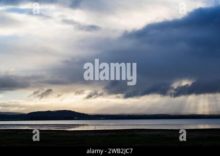 Rain clouds and sun rays over Findhorn bay nature reseve and Cluny hill. Findhorn, Morayshire, Scotland Stock Photo