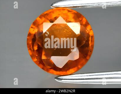 Natural orange hessonite garnet gem on background Stock Photo