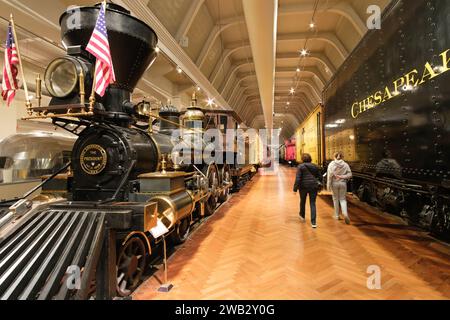 On the right, the 1858 Rogers 4-0-0 wood-burning steam locomotive, The President, at The Henry Ford Museum of American Innovation Stock Photo