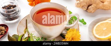 Tea with herbs, fruits, and flowers panorama, shot on a white background. Healthy natural remedy Stock Photo