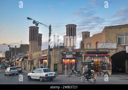 Wincatchers on buildings along Salman-e-Faarsi on the north side of the Amir Chakhmaq Complex at dusk. Yazd, Iran Stock Photo