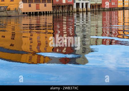 reflections of colourful waterfront warehouses wharfs buildings of Bakklandet in river Nidelva at Trondheim, Norway, Scandinavia, Europe in October Stock Photo