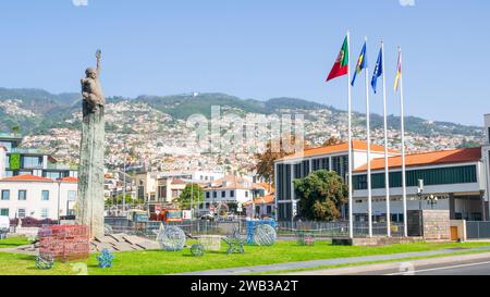 Funchal Madeira Praça da Autonomia Autonomy Square with flags and historical monument a bronze statue of a woman in Funchal Madeira Portugal EU Europe Stock Photo