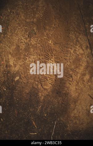 A top view of footsteps of boots on sandy ground in Algonquin Provincial Park in Ontario, Canada Stock Photo