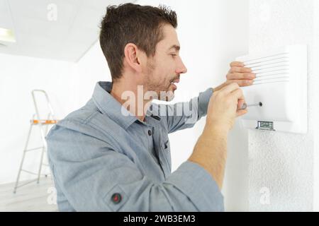 male repairman connecting pipes indoors Stock Photo