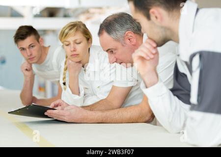 row of pensive students on decorating course Stock Photo