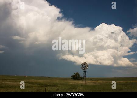 Storm clouds gathering over rural South Africa, with a windpump in the foreground. Stock Photo