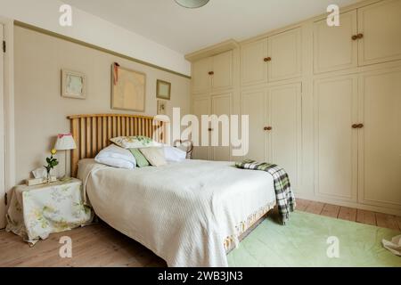 Impington, Cambridgeshire - March 7 2015: Traditional Furnished Bedroom with built in wardrobes Stock Photo