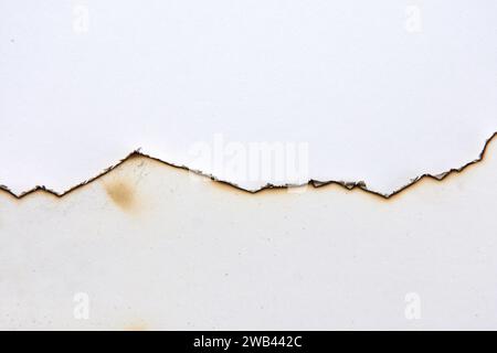 line of burnt paper on white background Stock Photo