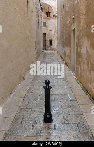 Narrow empty medieval alleyway in Malta Stock Photo