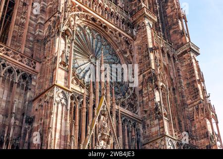 Close-up view of Cathedrale Notre Dame de Strasbourg in France Strasbourg city. Detail gothic architecture rose window stained glass facade wall of Stock Photo